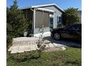 Charming home featuring vinyl siding, and a paved driveway and patio for outdoor gatherings at 50989 Highway 27 # 210, Davenport, FL 33897