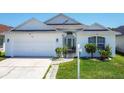 Inviting single-story home with a well-manicured lawn, attached garage, and bright exterior at 529 Eagle Pointe N, Kissimmee, FL 34746