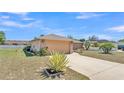 Charming single-story home with attached two-car garage and tidy landscaping at 6056 Hillside Heights Dr, Lakeland, FL 33812