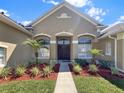 Charming front entrance with well-maintained landscaping and double-door entry at 6132 Waterfield Way, St Cloud, FL 34771