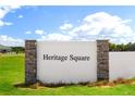 Entrance to Heritage Square features stone pillars, attractive landscaping, and a welcoming community at 614 Heritage Square Dr, Haines City, FL 33844