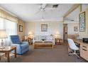 Cozy living room with large windows, comfortable seating and bright, natural light at 6711 Canterbury Ne Dr, Winter Haven, FL 33881