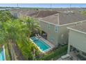Aerial view of backyard with a private pool, spa and lush landscaping at 7615 Brookhurst Ln, Kissimmee, FL 34747