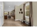 Inviting foyer featuring tile flooring, a window and access to the living areas at 7615 Brookhurst Ln, Kissimmee, FL 34747