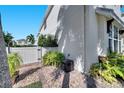 Brick and stone landscaping on the side yard with a white fence creating a quaint and private space at 8498 Powder Ridge Trl, Windermere, FL 34786