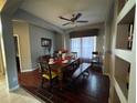 Elegant dining room with wood floors, a ceiling fan, and ample natural light at 8631 La Isla Dr, Kissimmee, FL 34747