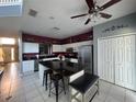Open kitchen featuring a large island, stainless steel appliances, and tile flooring at 8631 La Isla Dr, Kissimmee, FL 34747