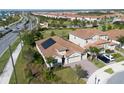 Lovely home featuring solar panels, a well-manicured lawn, and a paved driveway at 8999 Croquet Ct, Davenport, FL 33896