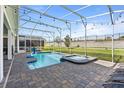 Private backyard with screened pool and spa, perfect for outdoor relaxation and entertaining at 9190 Sommerset Hills Dr, Davenport, FL 33896