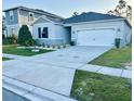 Attractive single-story home with a two-car garage, complemented by a well-manicured lawn at 1153 Augustus Dr, Davenport, FL 33896