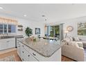 Open-concept kitchen featuring a large island, granite countertops, and stainless steel appliances at 1153 Augustus Dr, Davenport, FL 33896