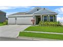 Charming single Gathering home with a well manicured lawn and 2-car garage at 14419 Topaghan Way, Winter Garden, FL 34787