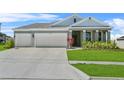 Charming single Gathering home with a well manicured lawn and 2-car garage at 14419 Topaghan Way, Winter Garden, FL 34787