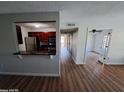 Bright living room with beautiful flooring and view into the kitchen area at 2031 Dixie Belle Dr # Q, Orlando, FL 32812