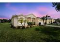 Charming single-story home with lush lawn, palm trees, and attractive landscaping at 213 Strathmore Cir, Kissimmee, FL 34744