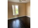 Bright bedroom featuring a ceiling fan, hardwood floors and a window bringing in natural light at 2320 Andrews Valley Dr, Kissimmee, FL 34758
