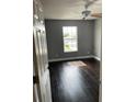 This bedroom has hardwood floors, a ceiling fan and a window that overlooks a green landscape at 2320 Andrews Valley Dr, Kissimmee, FL 34758