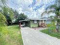 Exterior view of house featuring a car port and a well maintained front lawn at 2406 Thelma Ave, Haines City, FL 33844