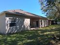 Spacious backyard with a covered patio, offering a tranquil outdoor living space at 2520 Azzurra Ln, Ocoee, FL 34761