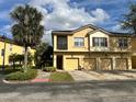 Inviting two-story townhome features a private screened balcony and attached garages at 2787 Oakwater Dr # 149, Kissimmee, FL 34747