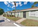 Street view of condo with tidy landscaping, neutral paint scheme, and available parking at 31 Las Palmas Way, Kissimmee, FL 34743
