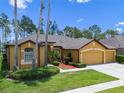 Inviting single-Gathering home with a three-car garage, lush lawn, and meticulously maintained landscaping at 310 N Hampton Dr, Davenport, FL 33897