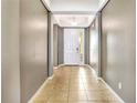 Inviting foyer with tiled floor leading to a bright white front door with sidelight at 3131 Bass Boat Way, Kissimmee, FL 34746