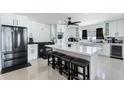 Modern kitchen featuring white cabinetry, stainless steel appliances, and a center island with seating at 3263 Lorimar Ln, St Cloud, FL 34772