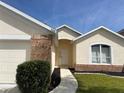 Inviting front entrance with a concrete walkway and manicured landscaping leading to the front door of the home at 366 Jaybee Ave, Davenport, FL 33897