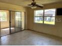 Bright living area with large windows and a sliding glass door to the outdoors at 4226 Lake Richmond Dr, Orlando, FL 32811