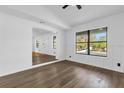 Open-concept living room featuring new flooring, fresh paint, and ample natural light at 4410 Rossmore Dr, Orlando, FL 32810