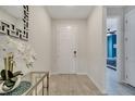 Welcoming entryway featuring neutral colors, a modern mirror, and a decorative floral arrangement at 4717 Weatherbell Rd, Winter Garden, FL 34787
