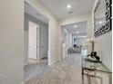 Bright hallway with tile flooring, leading to living spaces and bedrooms, offering a seamless flow at 4717 Weatherbell Rd, Winter Garden, FL 34787