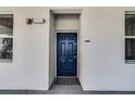 Inviting blue front door, framed by white exterior walls, providing a secure and stylish entrance at 4721 Clock Tower Dr # 106, Kissimmee, FL 34746