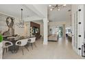 Open-concept dining and living area features modern lighting, tiled floor, and an inviting atmosphere at 4873 Old Oak Trl, St Cloud, FL 34771