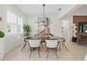 Elegant dining area with modern chandelier, sleek table, and comfortable seating at 4873 Old Oak Trl, St Cloud, FL 34771