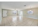 Bright, spacious living room featuring tile flooring, a ceiling fan, and natural light at 612 California Ave, St Cloud, FL 34769