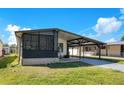 Charming single-story home with a covered carport and screened-in porch at 6462 Hollyberry Ne Ln, Winter Haven, FL 33881
