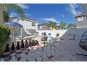 A beautiful backyard with a pool, hot tub, outdoor grill, and a giant chess set for entertainment at 7570 Excitement Dr, Reunion, FL 34747