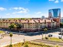 Beautiful apartment with balconies, lush green trees, and an open view to buildings in the distance at 911 N Orange Ave # 550, Orlando, FL 32801