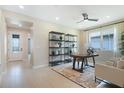 A well-lit home office featuring modern shelving, light wood-look floors and neutral tones at 1011 Wisteria Way, Dundee, FL 33838