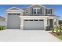 Stylish two-story home featuring a three car garage and beautifully landscaped front yard at 1138 Olivine Ave, Dundee, FL 33838