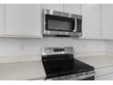 Modern kitchen featuring stainless steel appliances and beautiful quartz countertops at 1138 Olivine Ave, Dundee, FL 33838