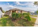 Well-maintained single-story home with manicured lawn and lush landscaping at 1187 Playa Del Sol Ln, St Cloud, FL 34771