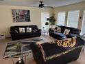 Spacious living room with stylish black couches and ample natural light at 133 Rona Ln, Davenport, FL 33897