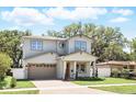 Charming two-story home featuring a brick driveway, attached garage, and well-manicured landscaping with green grass at 1436 Stetson St, Orlando, FL 32804