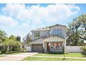 Charming two-story home featuring a brick driveway, attached garage, and well-manicured landscaping with green grass at 1436 Stetson St, Orlando, FL 32804