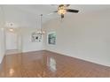 Bright, open-concept living area with wood-look tile floors and a breakfast bar connecting to the kitchen at 2435 King Oak Ln, St Cloud, FL 34769