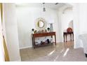 Bright entryway with a wooden console table, decorative mirror, and stylish decor at 2532 Ryland Falls Dr, Lakeland, FL 33811