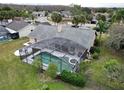 Aerial view of private screened pool and spa with lush landscaping in backyard at 2631 Eagles Nest Ct, Orlando, FL 32837